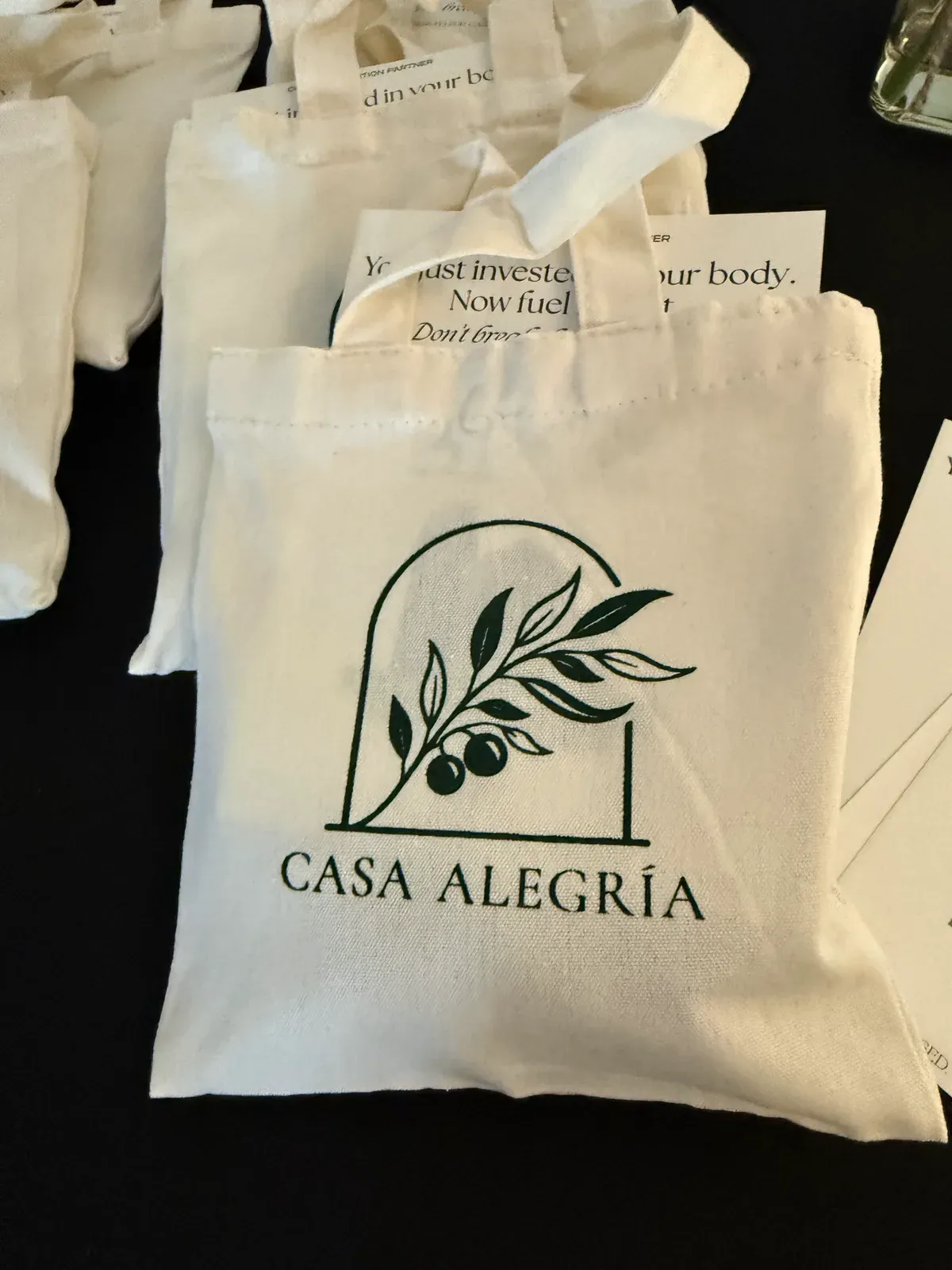 Casa Alegría tote bags laid out for guests at an event